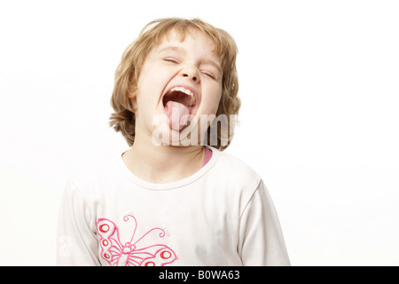 8-year-old girl sticking her tongue out Stock Photo