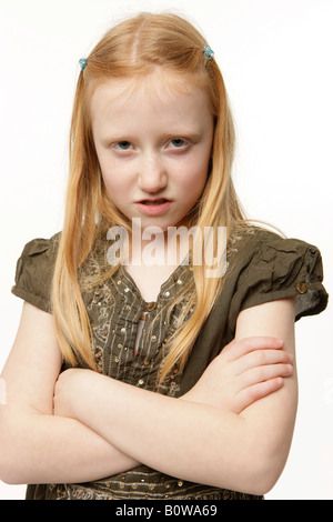 8-year-old girl, angry look, arms crossed Stock Photo