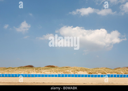Long row of colourful beach changing cabins in front of sand dunes, Vlissingen, Walcheren, Zeeland, Netherlands Stock Photo