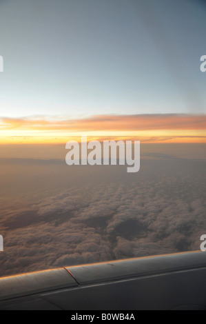 Sunset, view from an airplane window, wing, clouds