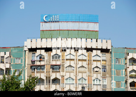 Socialist prefabricated building and Uzbek flag, Tashkent, Uzbekistan, Central Asia Stock Photo