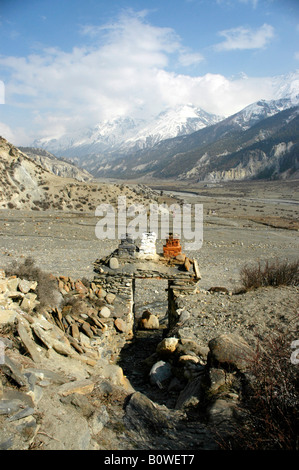 Painted stone gateway leading out into the barren Manang Valley, Annapurna Region, Nepal, Asia Stock Photo