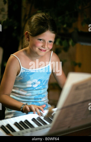 Young girl playing the piano Stock Photo