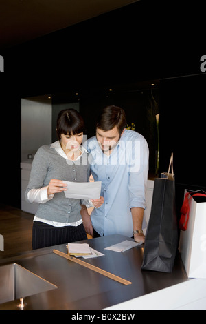 A man and a woman reading a letter Stock Photo