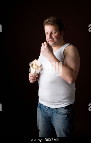 Stereotypical Englishman frowning at a chip Stock Photo