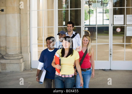 University students leaving a classroom building on campus Stock Photo