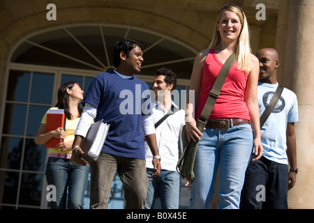 University students leaving a classroom building on campus Stock Photo