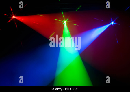 Three multi colored spotlights crossing light beams