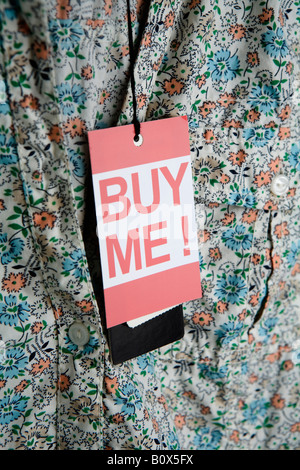 ‘Buy Me!’ price tag hanging from a lady’s blouse Stock Photo