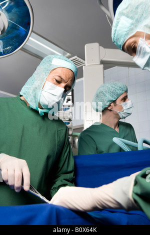Surgeons operating on a patient Stock Photo