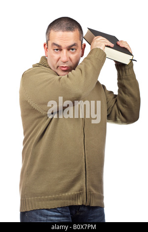 A serious casual man holding a book over white background Stock Photo