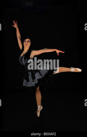 Victorian Ballerina, beautiful raven haired gothic in a black and grey dress pointed Stock Photo