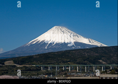 Japan. A view of Mount Fuji from the shinkansen (bullet train), with a motorway viaduct in the foreground Stock Photo