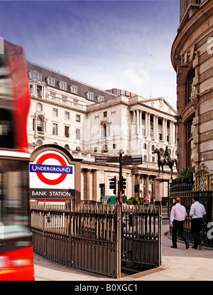 Red Double Decker Bus Passes the Bank of England at Bank Underground Station business men suits blurred daytime Stock Photo