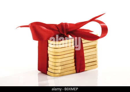 Gold bars with red bow Stock Photo