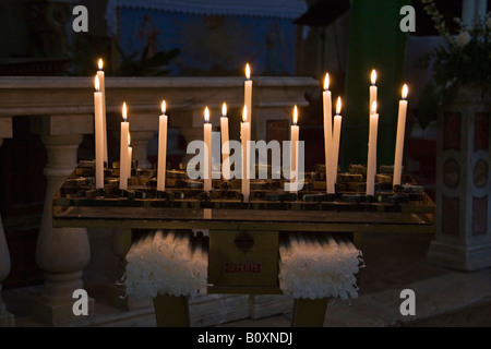 Italy, Tuscany, Lit Candles in church Stock Photo