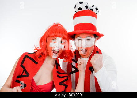Austrian and Swiss soccer fans, EURO 2008. Man and woman with clenched fists Stock Photo