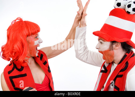Austrian and Swiss soccer fans, EURO 2008. Man and woman, cheering together Stock Photo