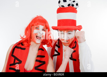 Austrian and Swiss soccer fans, EURO 2008. A man and a woman cheering with clenched fists Stock Photo