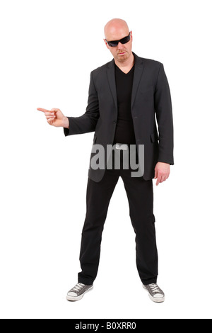 bald headed man pointing with his index finger to the side Stock Photo