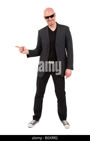 bald headed man pointing with his index finger to the side, smiling at the camera Stock Photo