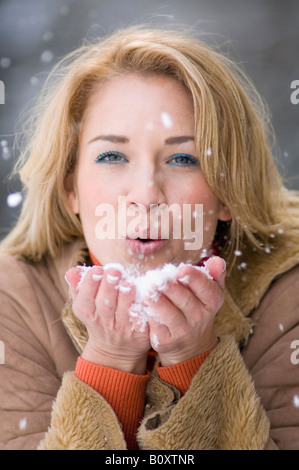 Austria, Salzburger Land, Altenmarkt, Young woman frolicking in the snowy woods, portrait Stock Photo