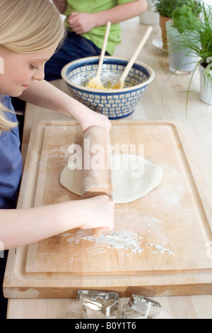 Girl (8-9) preparing dough Stock Photo