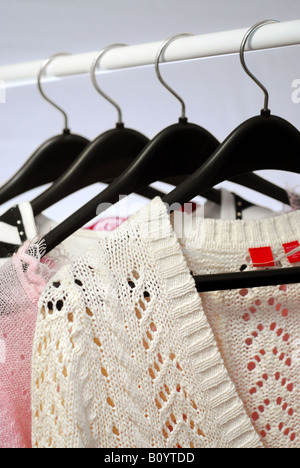 Women s clothing on a rack on black hangers Stock Photo
