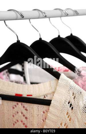 Women s clothing on a rack on black hangers Stock Photo