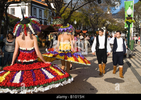 dh Flower Festival FUNCHAL MADEIRA Girl in flower costume walking in street and mens traditional outfits costumes dresses carnival Stock Photo