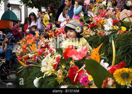 dh Flower Festival FUNCHAL MADEIRA Child on the Wall of Hope posing for photograph flowers kid Stock Photo