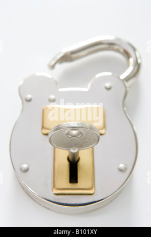 unlocked padlock with key on white background Stock Photo