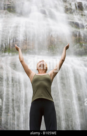 Woman poses in front of waterfall Stock Photo - Alamy