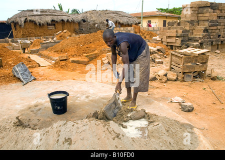 Man mixing cement on a construction side, Kuluedor, Ghana Stock Photo