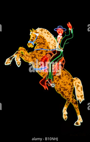 Neon Cowboy riding a horse on the old strip in downtown Las Vegas Nevada Stock Photo