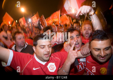 MANCHESTER MAY 21 Delirious Manchester United fans celebrate outside Old Trafford after their team won the UEFA Champions League Stock Photo