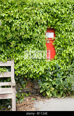 gpo red post box and village seat Stock Photo