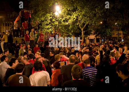 Delirious Manchester United fans celebrate in Manchester city centre after their team won the UEFA Champions League. Stock Photo