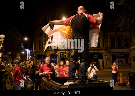 Delirious Manchester United fans celebrate in Manchester city centre after their team won the UEFA Champions League. Stock Photo