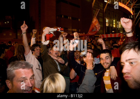 MANCHESTER MAY 21, 2008 Manchester United fans celebrate outside Old Trafford after their team won the UEFA Champions League. Stock Photo