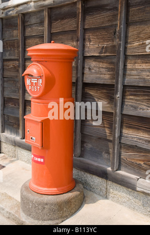 A traditional red Japanese post box outside a house in Shimoda ...