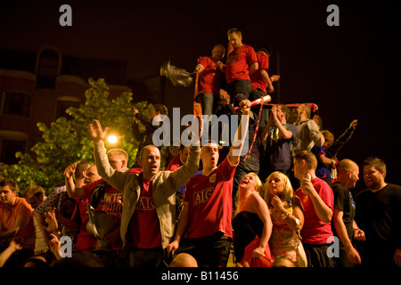 Delirious Manchester United fans celebrate in Manchester city centre after their team won the UEFA Champions League. Stock Photo