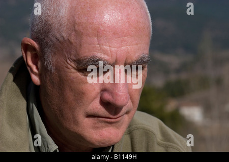 mature gentleman sitting outdoors looking dejected Stock Photo