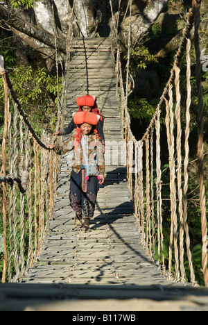 Woman Crossing Rope Two Red Dzao women crossing rope bridge Cat Cat Valley near Sapa ...