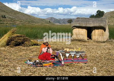 Local woman at a traditional Urus Iruitos reed village on the banks of Lake Titicaca in Bolivia Stock Photo