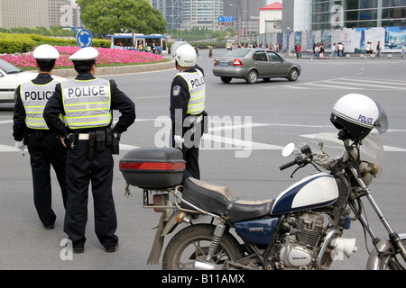 Chinese traffic policemen at a roundabout in Shanghai China Stock Photo