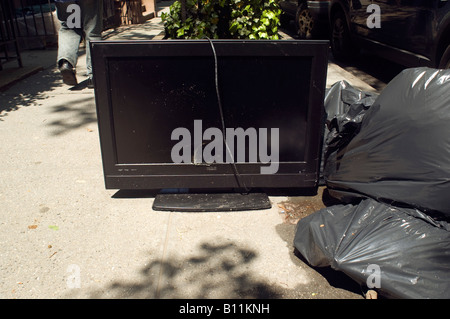 Broken television set awaiting pick up sanitation department Stock Photo