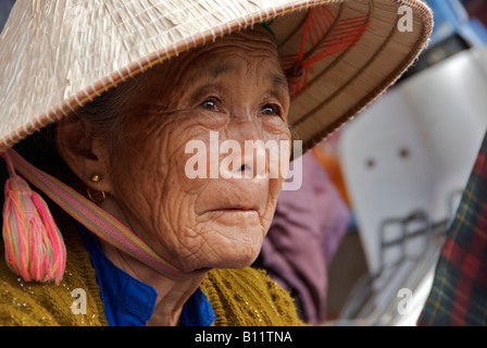 Portrait elderly Flower Hmong woman in straw hat Bac Ha Sunday Market Northern Vietnam Stock Photo