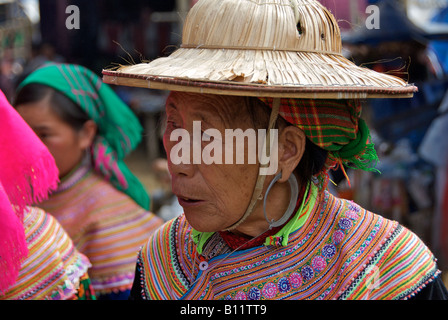 Portrait elderly Flower Hmong woman in straw hat Bac Ha Sunday Market Northern Vietnam Stock Photo