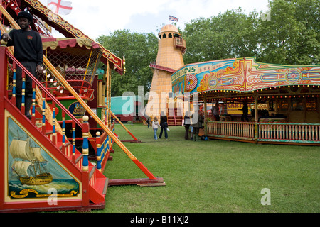 50s People Summer classic coconut throwing fair funfair helter skelter merry go round swings Stock Photo